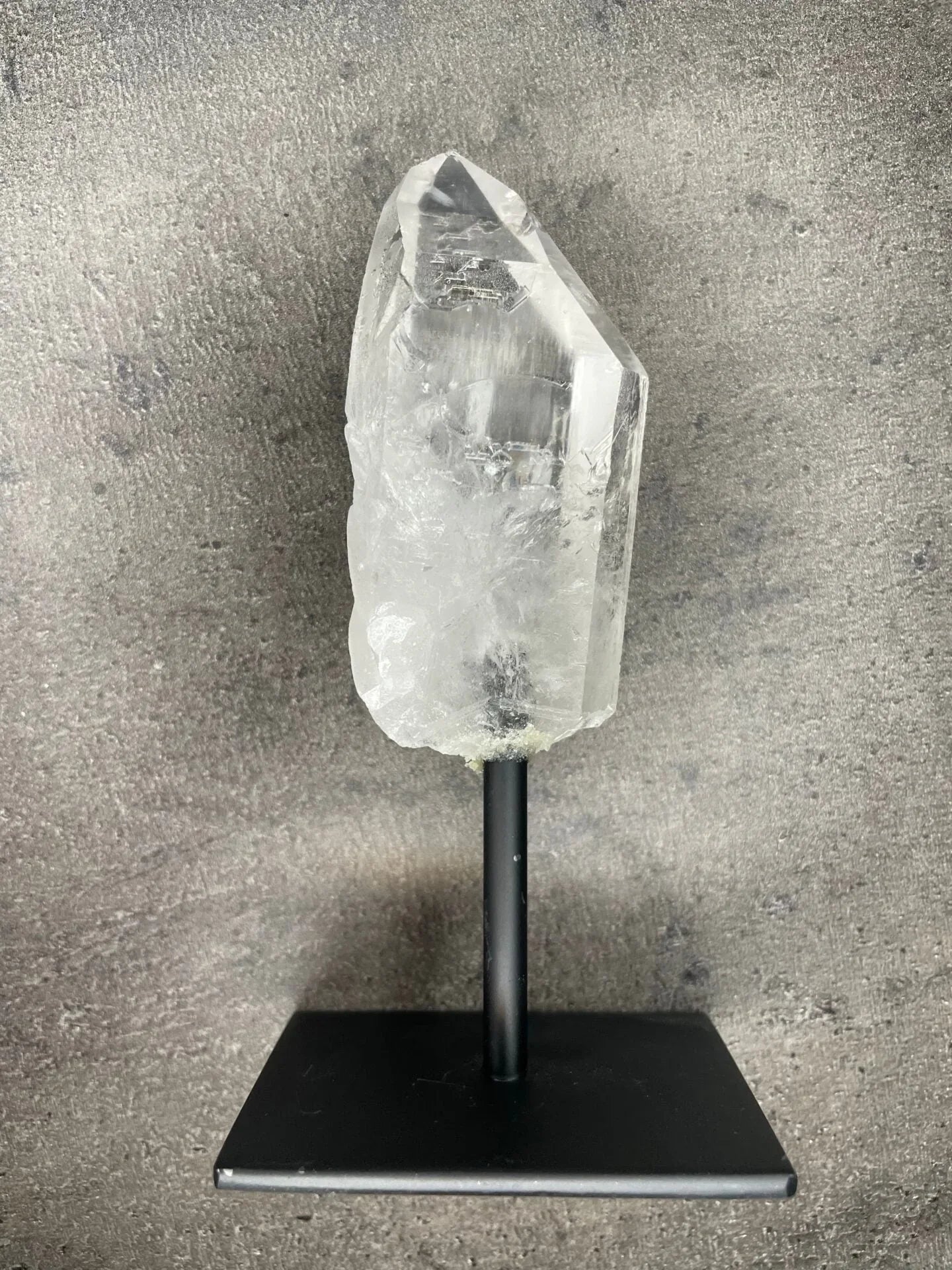 Clear quartz - Rough point on a stand
